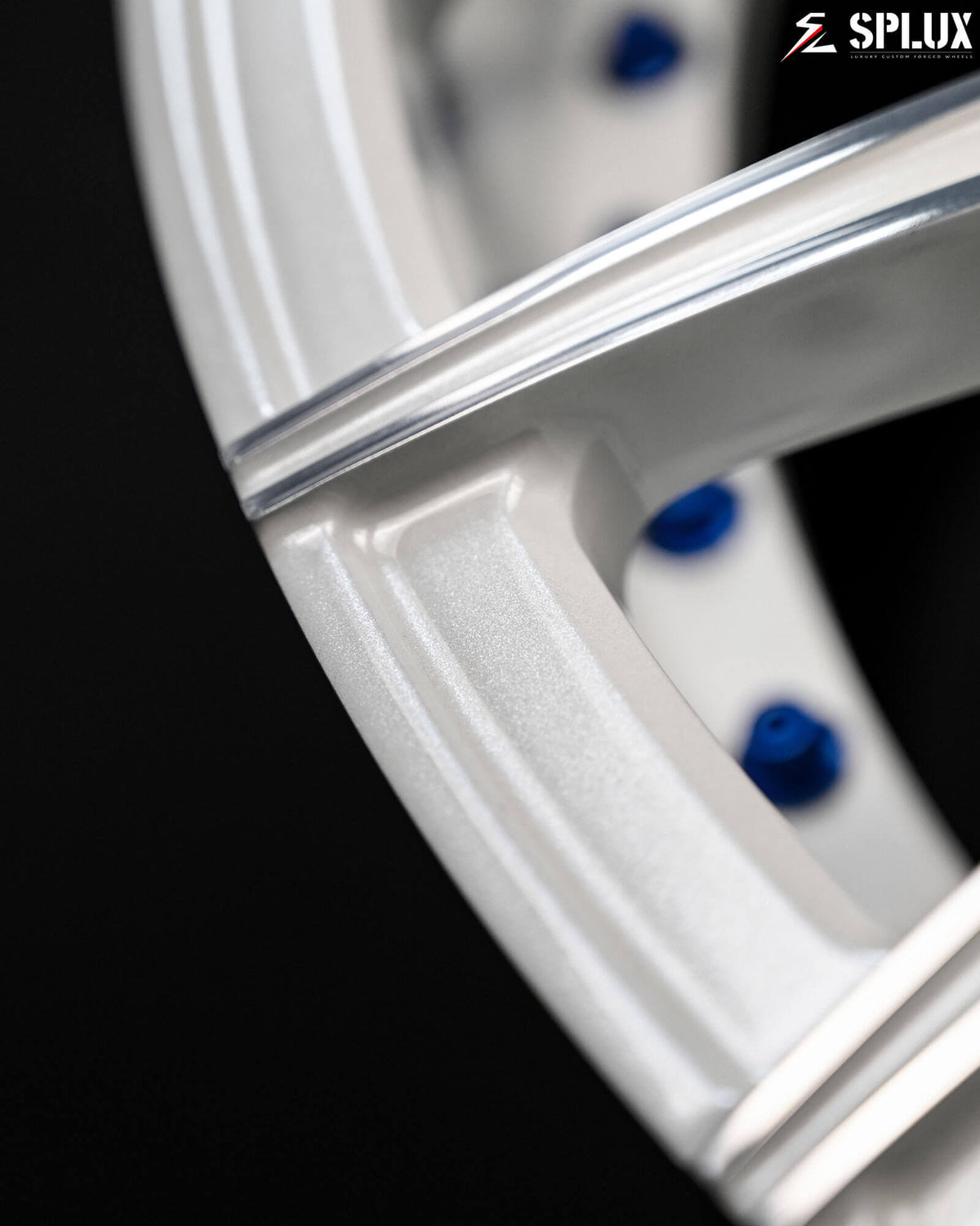 Corvette C6 rims in a deep concave design, featuring a white and black finish. Blue rivets complement the blue interior.