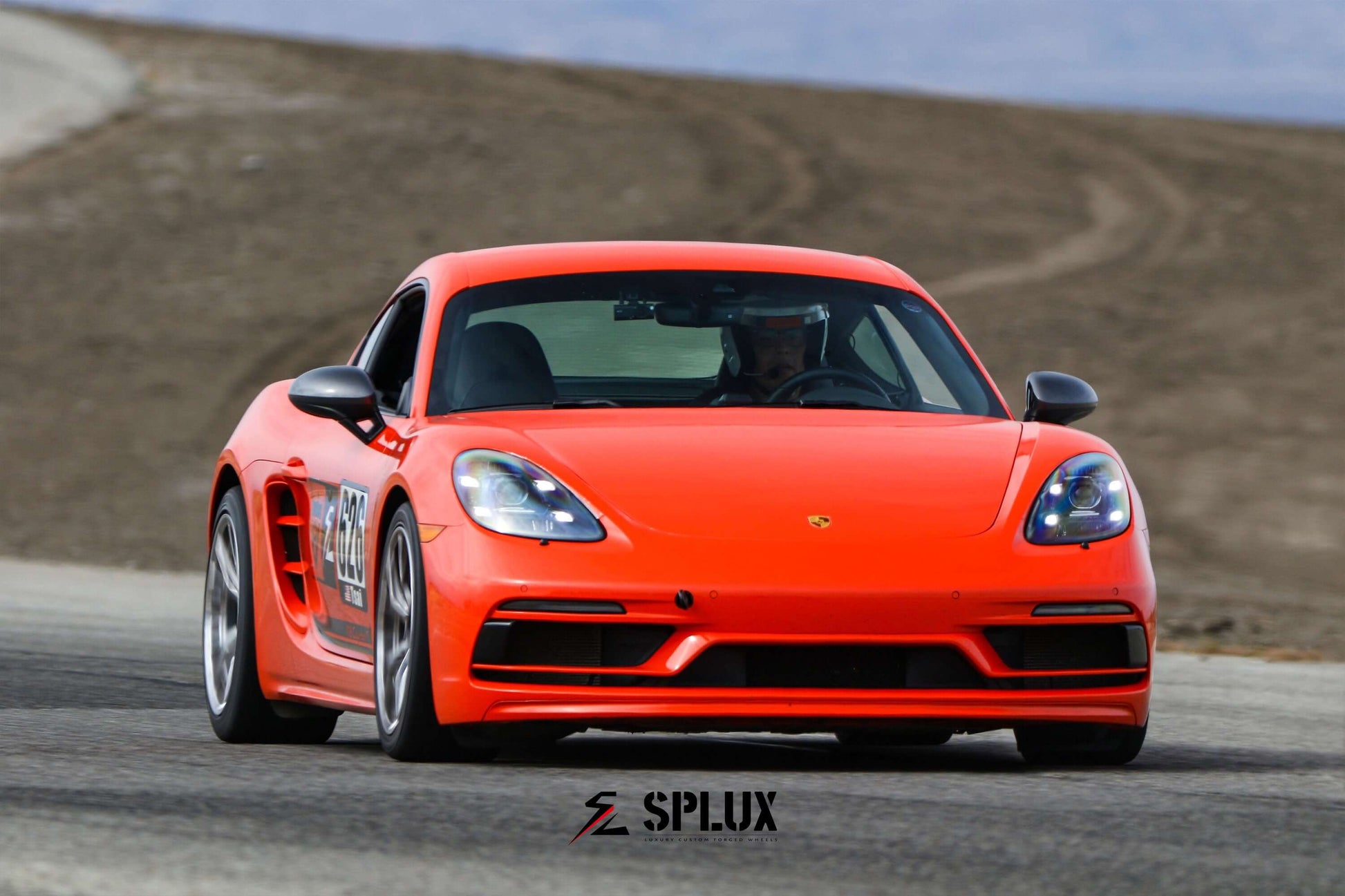 Porsche 718 Cayman in vibrant orange on tamale track days, showcasing super lightweight SL-03R wheels with concave Y-spoke design.