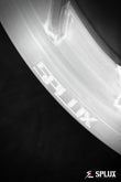 Rear SA-10 wheel with brushed aluminum surface and directional design on a Corvette C4