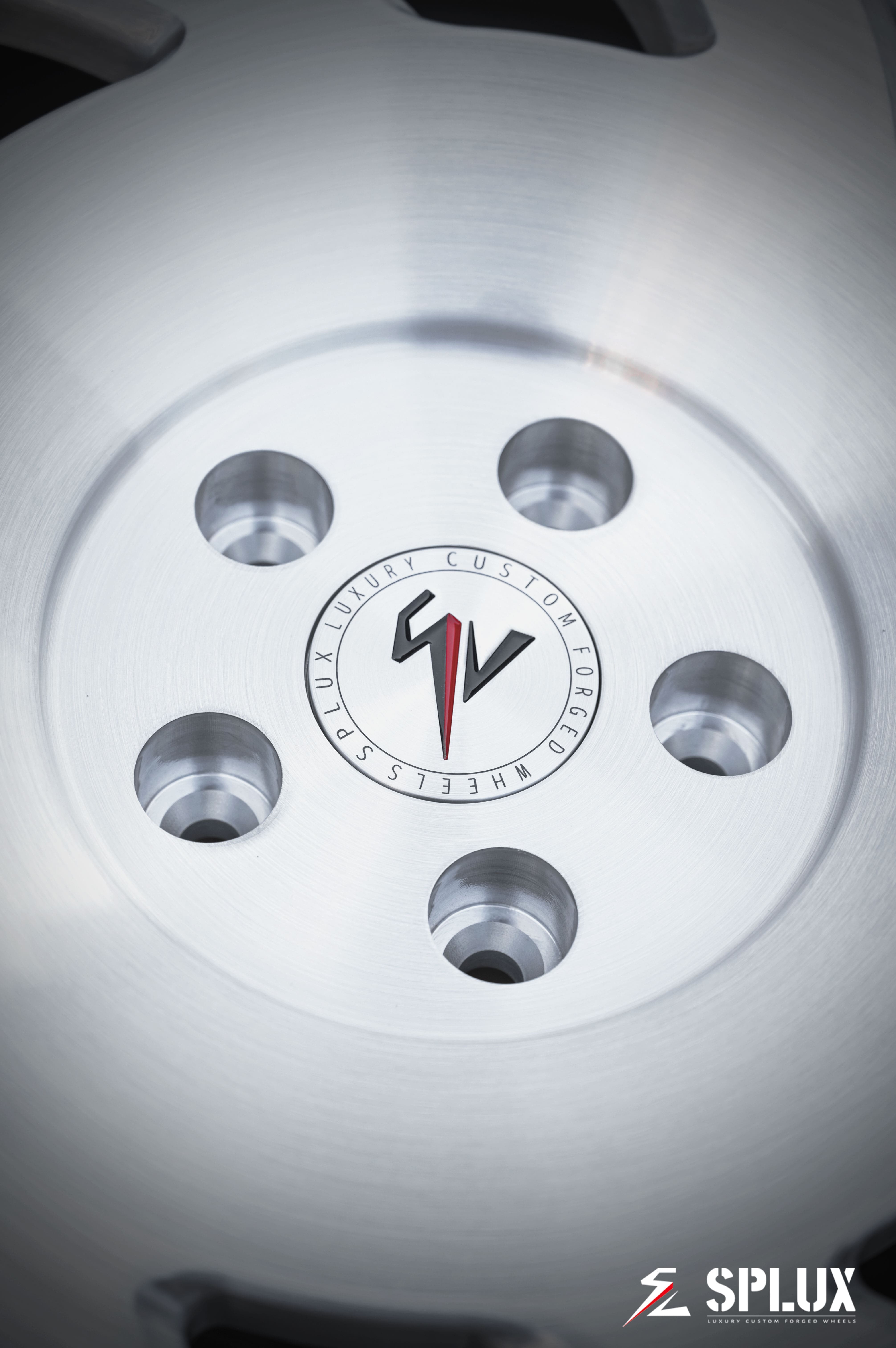Close-up of SA-10 forged wheel showing brushed aluminum texture and directional spoke pattern