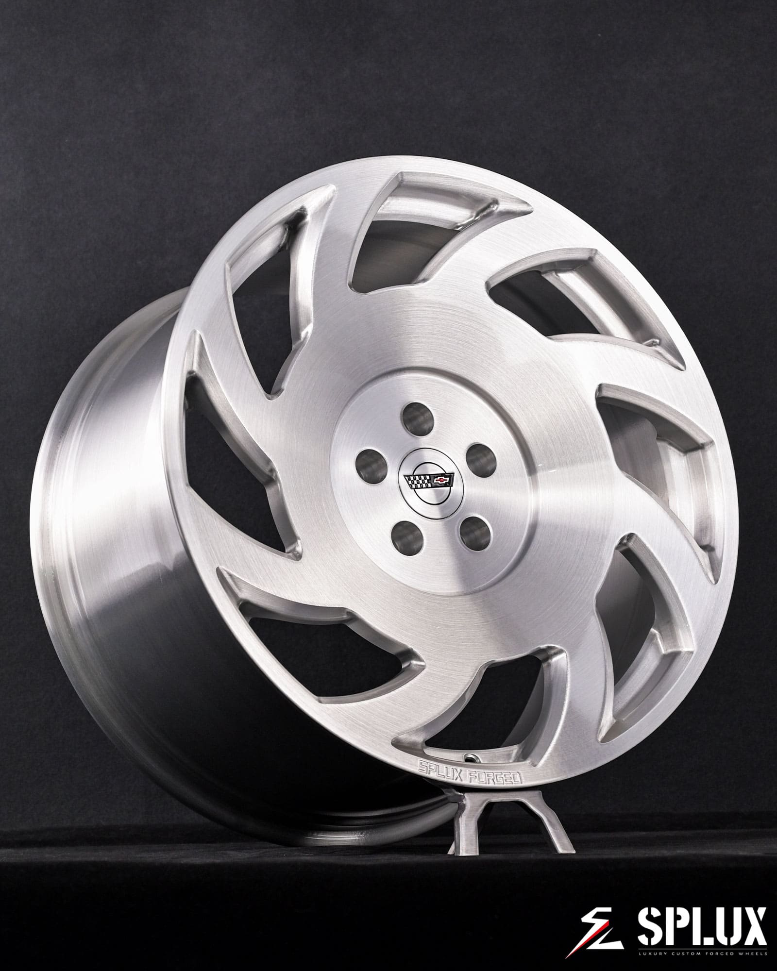 SA-10 forged wheel on the front of the Corvette showing directional spokes and brushed aluminum finish