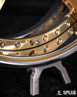 Close-up of the SD-06 wheel showing the polished frozen gold spokes and chrome rim