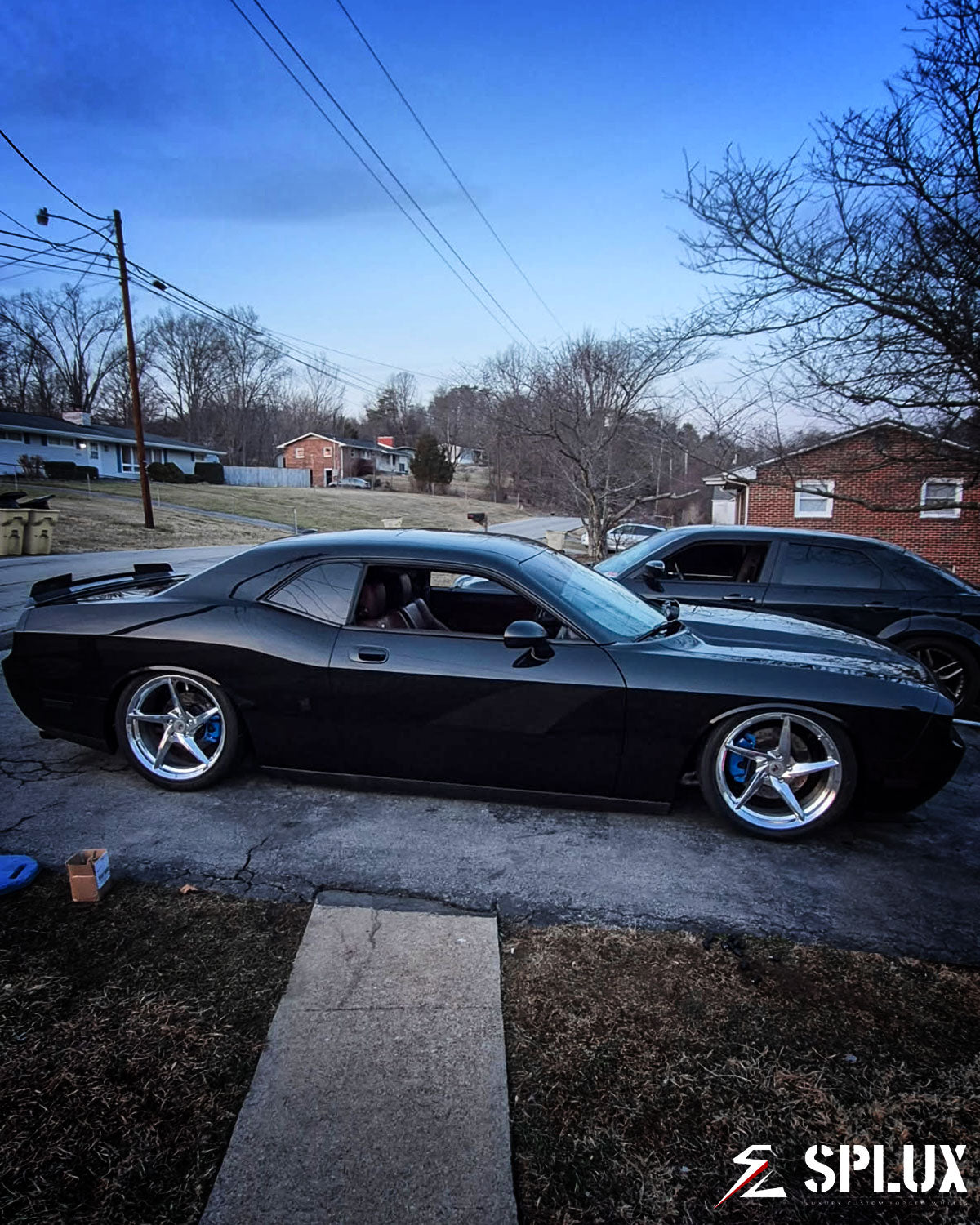 challenger with concave wheels low angle hero shot emphasizing black muscle car stance