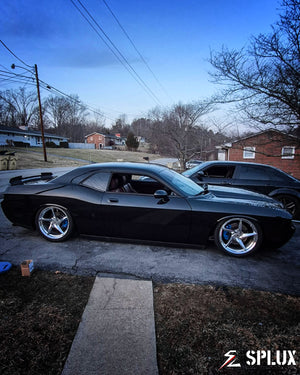 challenger with concave wheels low angle hero shot emphasizing black muscle car stance