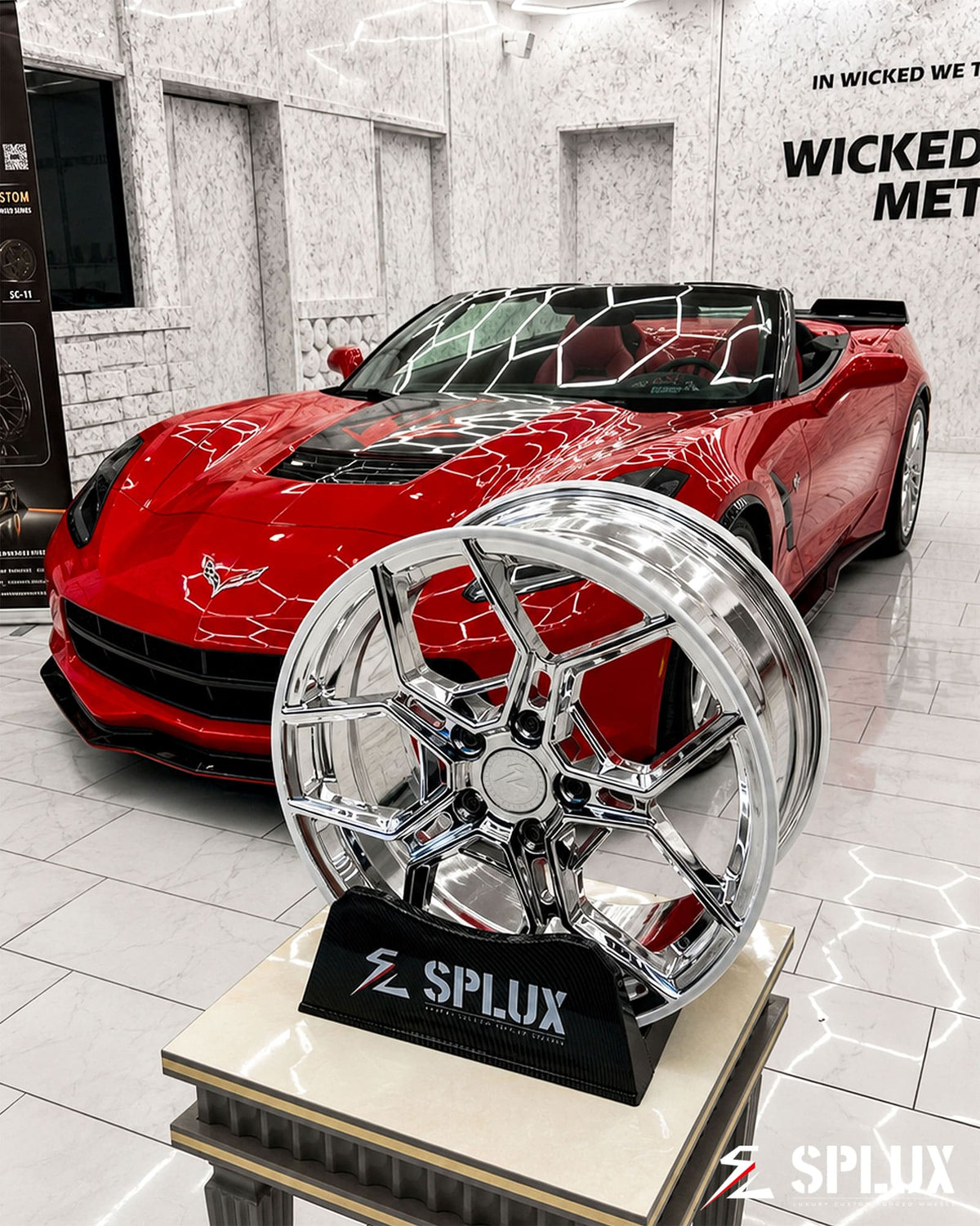 Front 18-inch SC-18M wheel on red Corvette showing five split spokes and chrome finish
