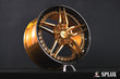 Close-up of the SA-01 wheel showing polished copper spokes and custom center cap