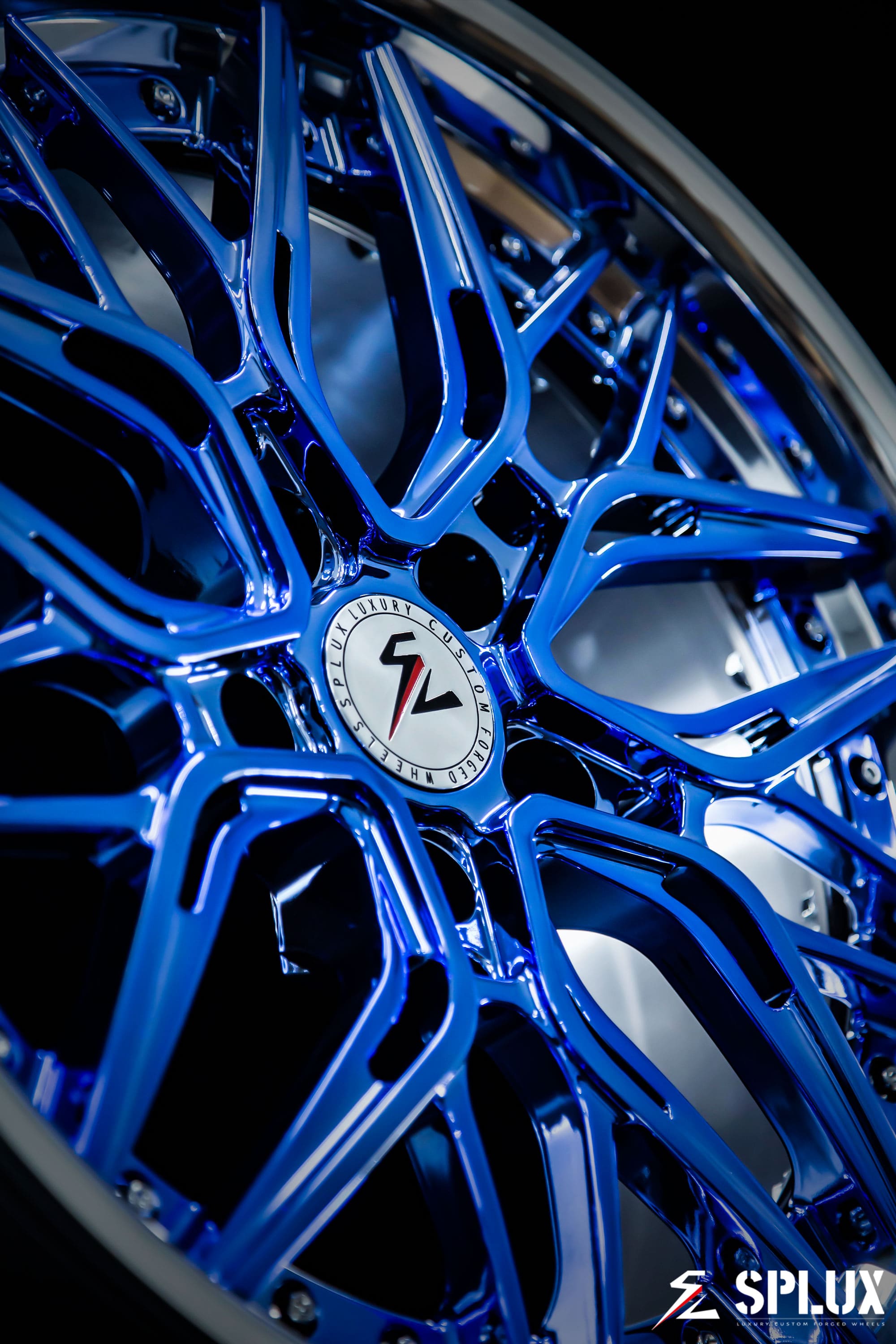 Close-up of the SC-02 wheel's polished barrel and chrome blue spokes with visible lug holes