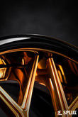 Polished Copper SA-01 spokes against a Piano Black barrel