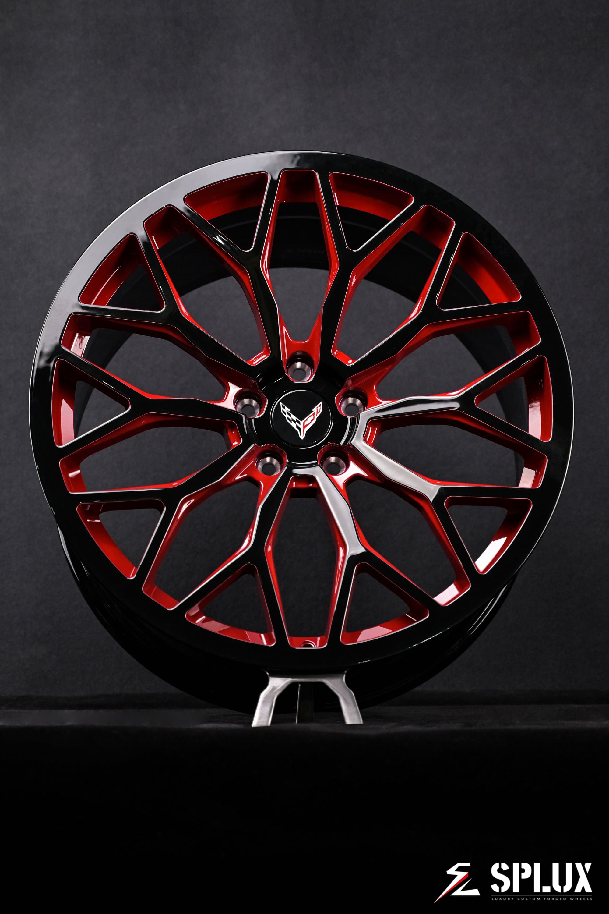 SC-14M forged wheel with piano black spokes and red accent, custom Corvette C8 logo center cap visible