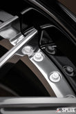 Polished aluminum spokes contrasted against a piano black barrel