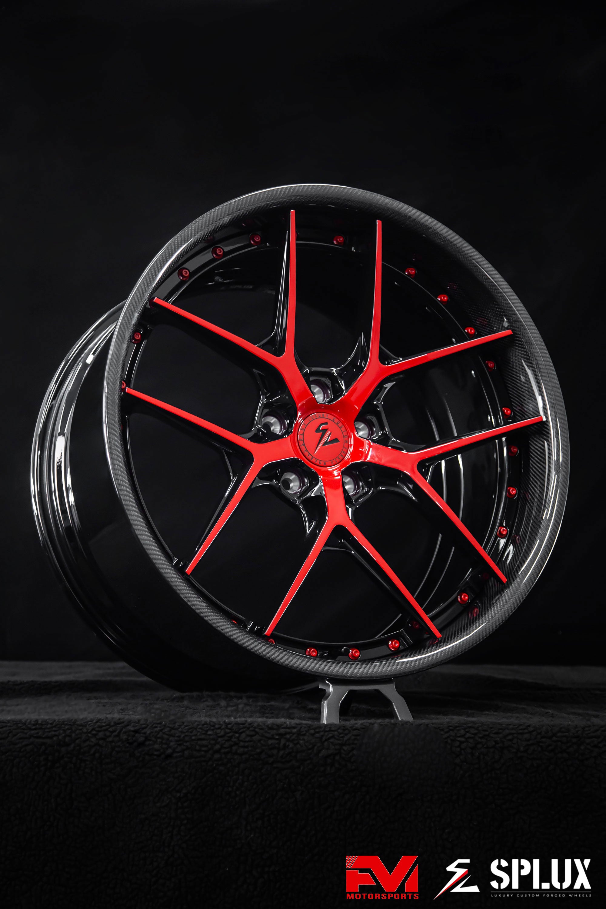 C8 Corvette wheels with a gloss red spoke face against piano black