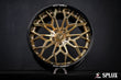 Close-up of the SD-08 wheel showing the deep-dish barrel in piano black and gold spokes