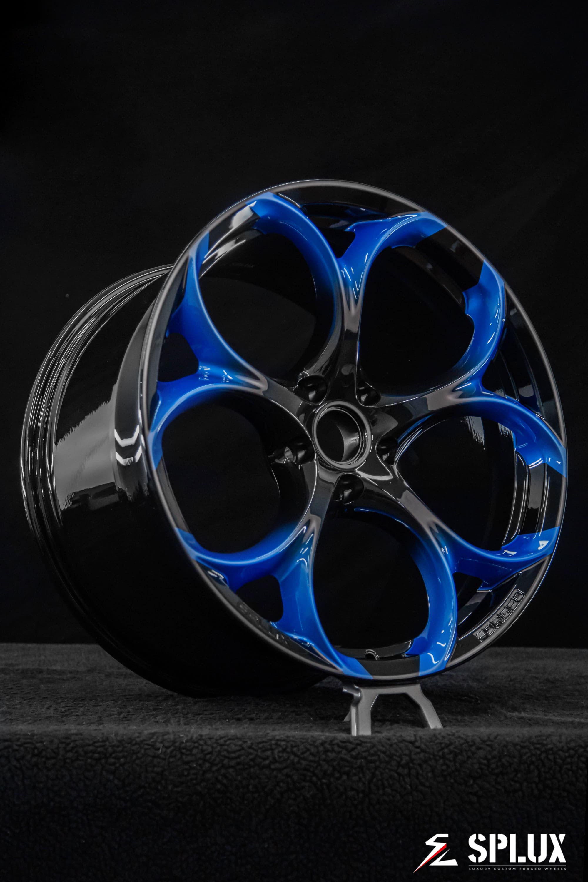 Close-up of the SC-07M wheel showing the piano black fade to Riptide Blue and five lug holes