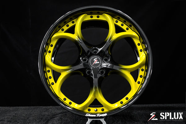 2026 Corvette rims with a piano black barrel and yellow spokes fading to black